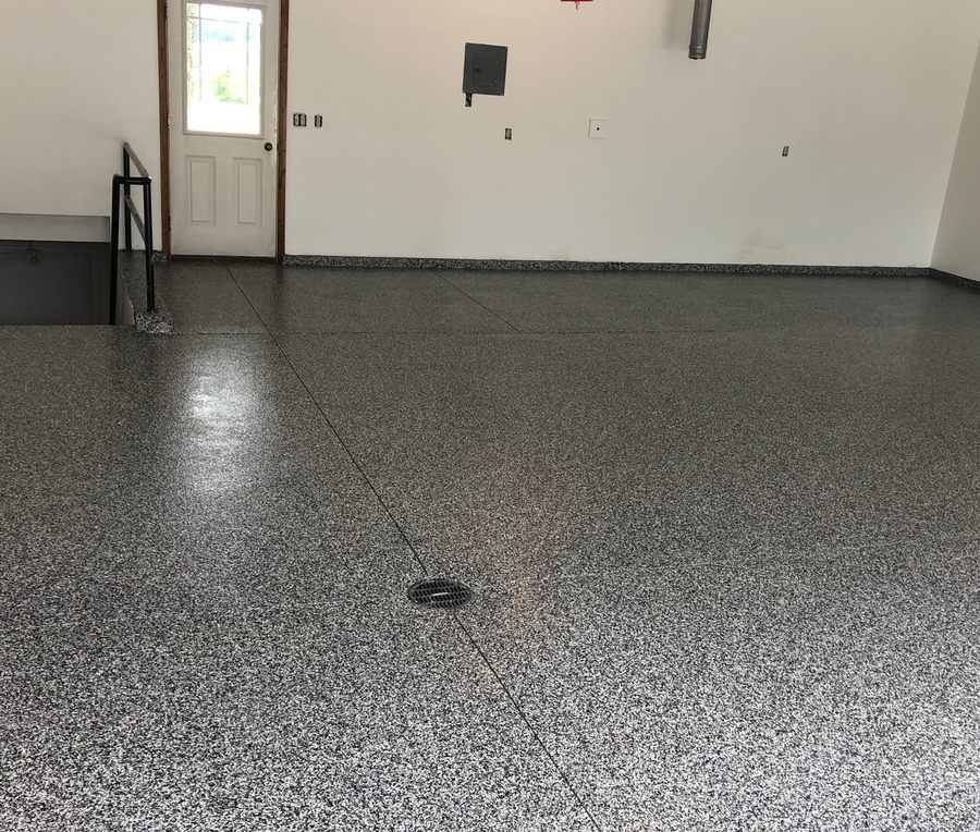 The same garage after installation, with a full flake polyurea floor coating.